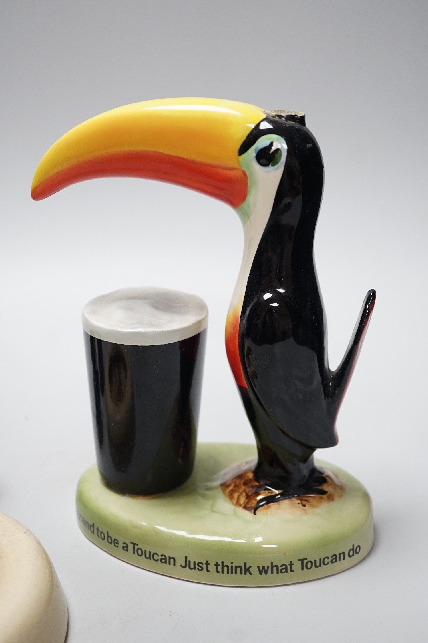 A Guinness toucan lamp-stem, 26cm high, and three related items